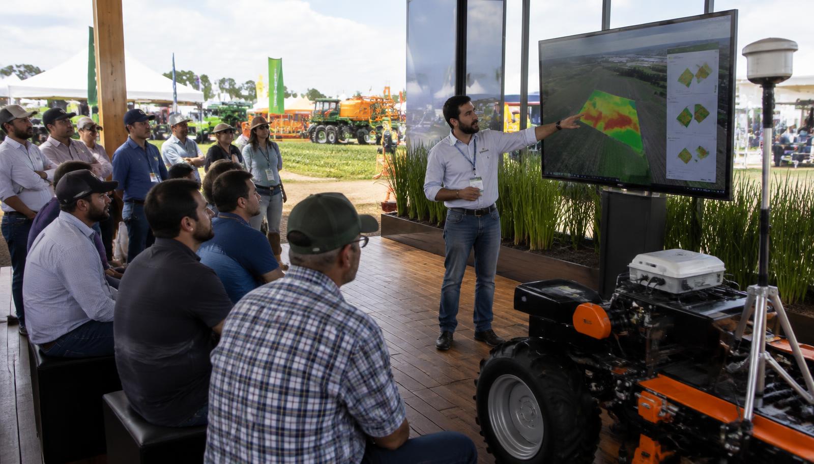 Especialista demonstra tecnologia de agricultura de precisão para produtores em stand aberto